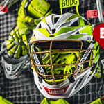 Bright yellow and lime green helmet, sticks, gloves, pads, and cleats are placed next to each other in front of a net on a dark pink background, showcasing affordable lacrosse gear. A label 'Budget pick' hangs next to the items, along with a large dollar sign symbol.