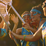 Female Lacrosse players celebrating a goal while playing women’s Lacrosse, tight composition emphasizing emotional connection and trust.