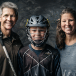 A portrait of two parents standing proudly with their teenager in Lacrosse gear, each parent holding a Lacrosse stick, helping youth Lacrosse improve, everyone smiling with confident and determined expressions.